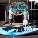 Butch Tripp accepting the donation of 2 kayaks from Old Town Canoe, Jeremy Smith