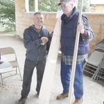 Jerry LeBeau presenting Skip Trask with a stretcher signed by trappers.